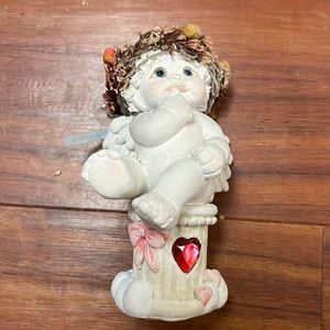 Cherub sitting on a pedestal